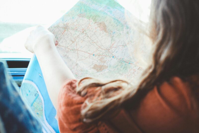 Girl Holding a Map for a Road Trip